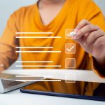 Person checking boxes on digital checklist representing website launch checklist article on Host Easy (Australian web hosting)