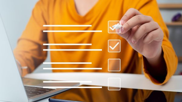 Person checking boxes on digital checklist representing website launch checklist article on Host Easy (Australian web hosting)